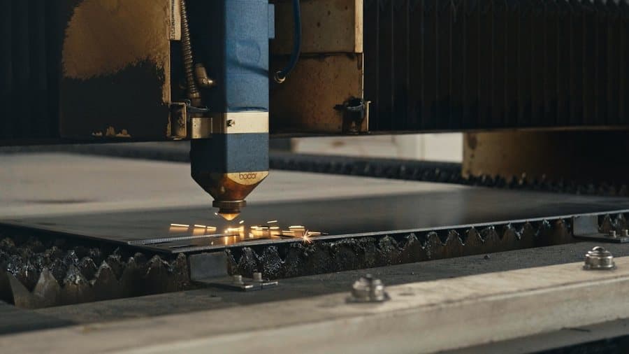CNC cutting head tracking across a steel sheet