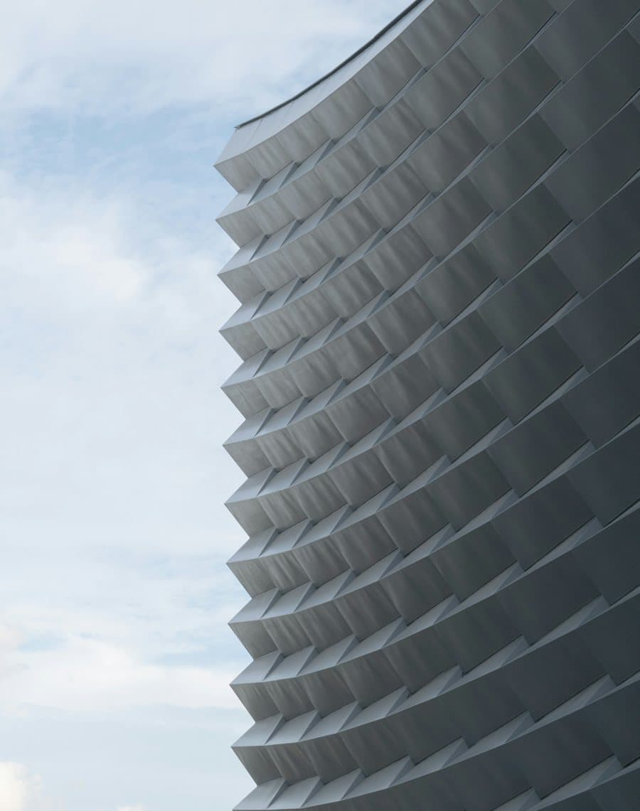 Folded metal facade panels stepping across a building elevation