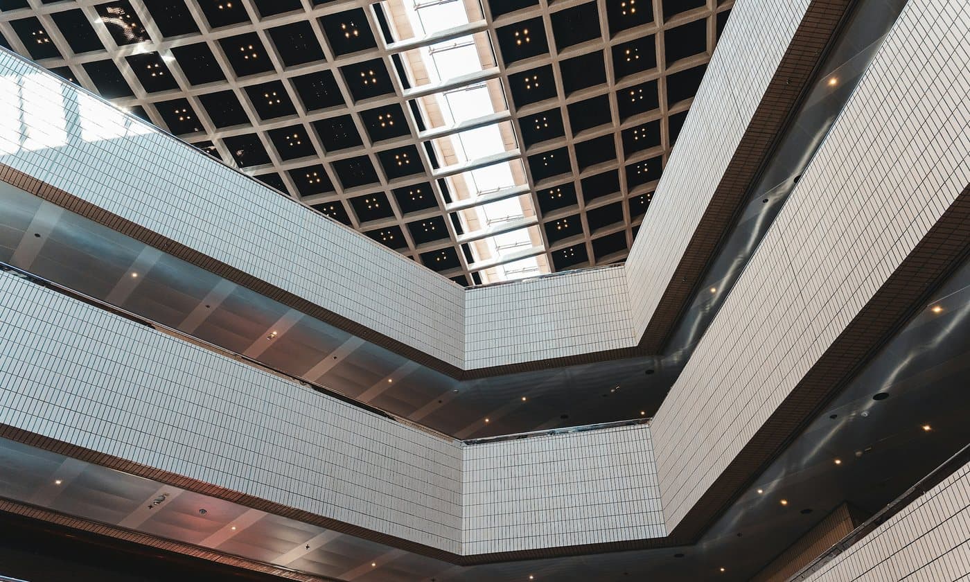 Civic atrium under a geometric coffered ceiling