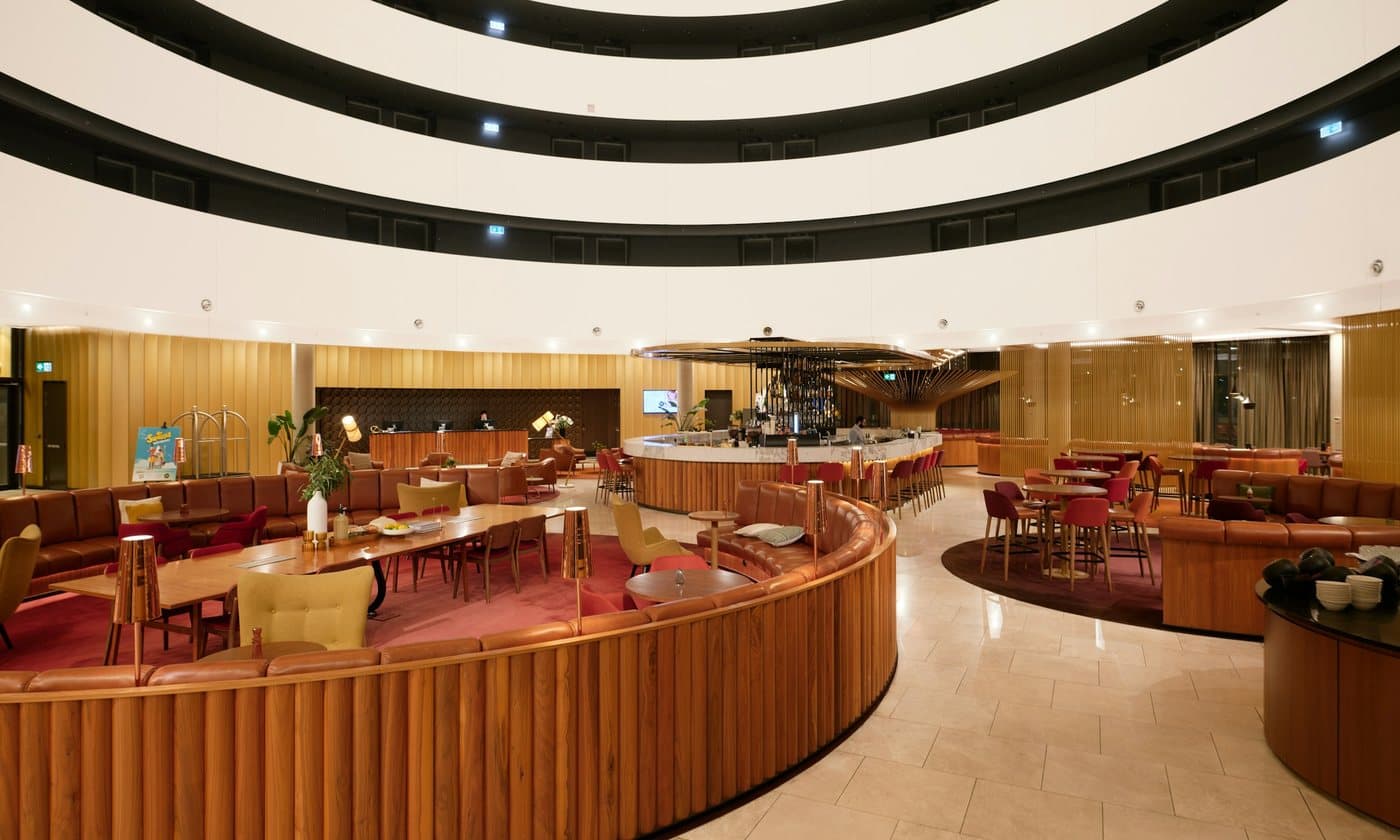 Hotel lobby wrapped in curved timber walls